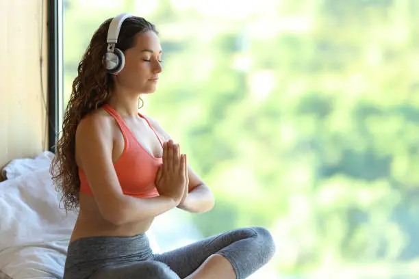 yogi with headphones listening yoga audio guide