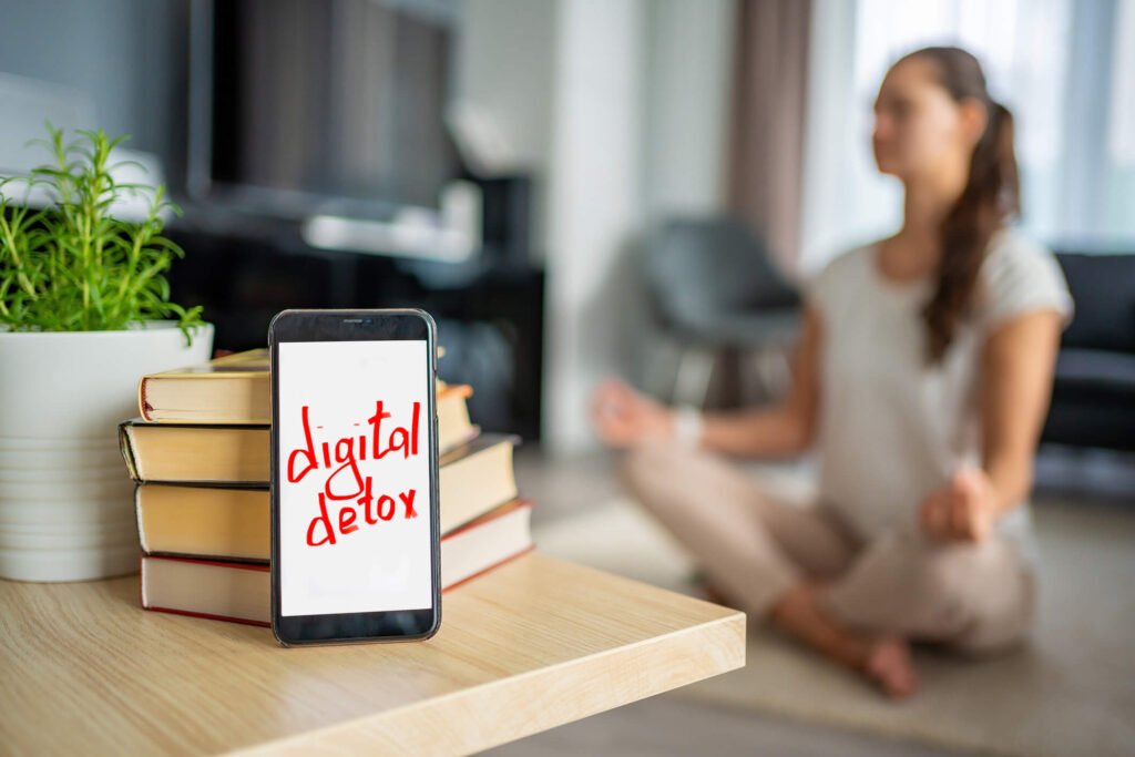 Blog "Woman meditating outdoors, representing the anxiety-reducing benefits of a digital detox."