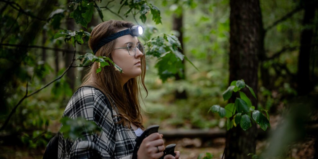 “Woman meditating in nature with phone set aside, reflecting mental health improvement through digital detox.”
