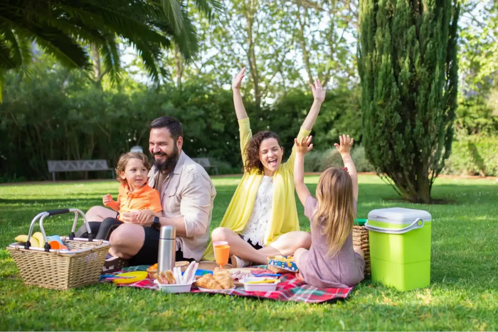 Parents and kids sharing outdoor time together, part of a family unplugging routine built on screen‑free bonding.
