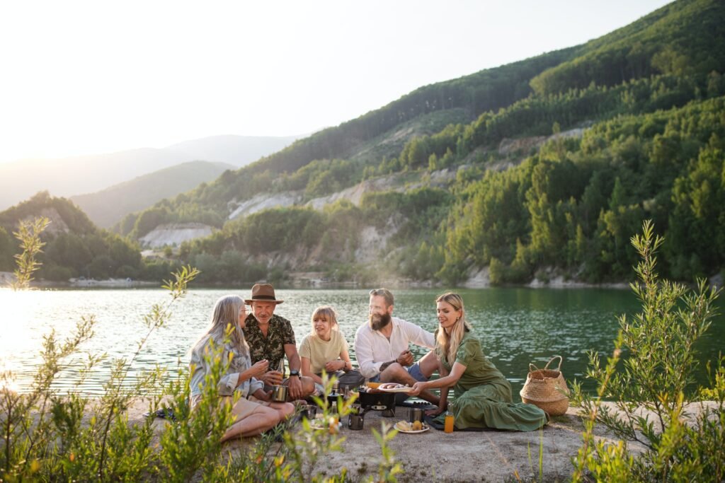 Family enjoying a peaceful lakeside moment as part of their daily unplugging practice, embracing real connection and relaxation