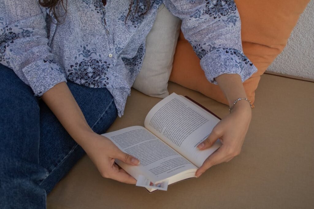 Blog Person relaxing with a book in hand, embodying the ultimate no‑screen rule and peaceful routines to reclaim inner calm.