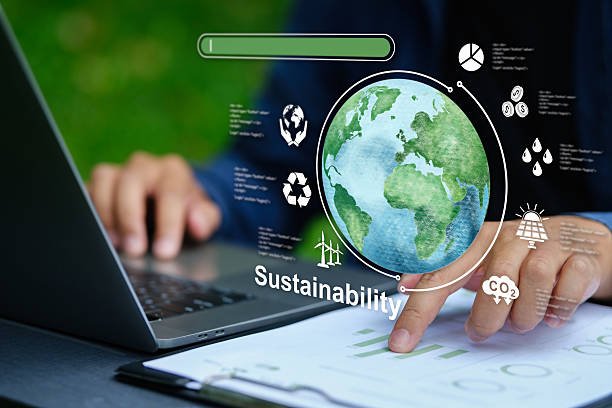 Blog Close-up of businessmen at a computer, analyzing data visualizations about sustainability, CO2 emissions, and green business solutions, highlighting corporate responsibility.