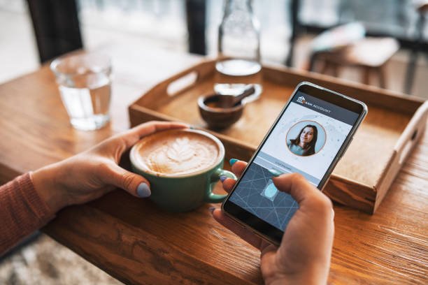 Blog A user mindful of their financial security, securely accessing their digital bank account on a mobile phone through fingerprint authentication