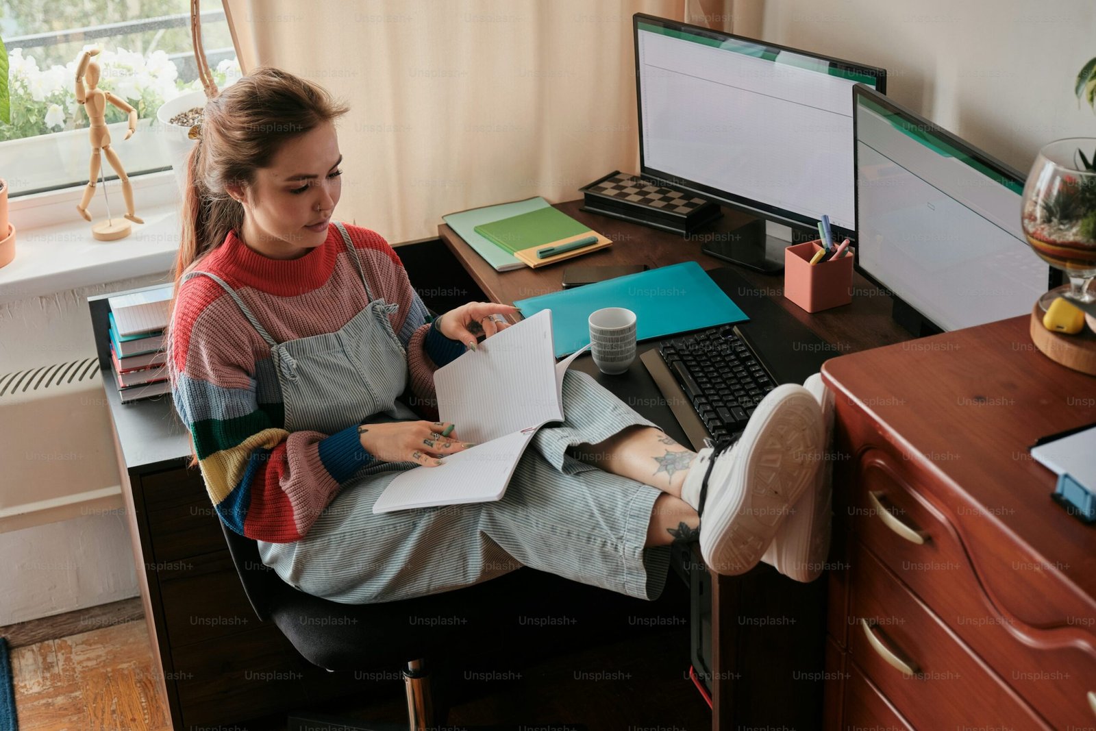 A woman sitting at a desk working on a computer