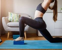 Stay Safe, Get Strong: 7 Essential At-Home Workout Safety Tips A woman demonstrating proper form while exercising on a mat, following essential at-home workout safety tips to prevent injury.