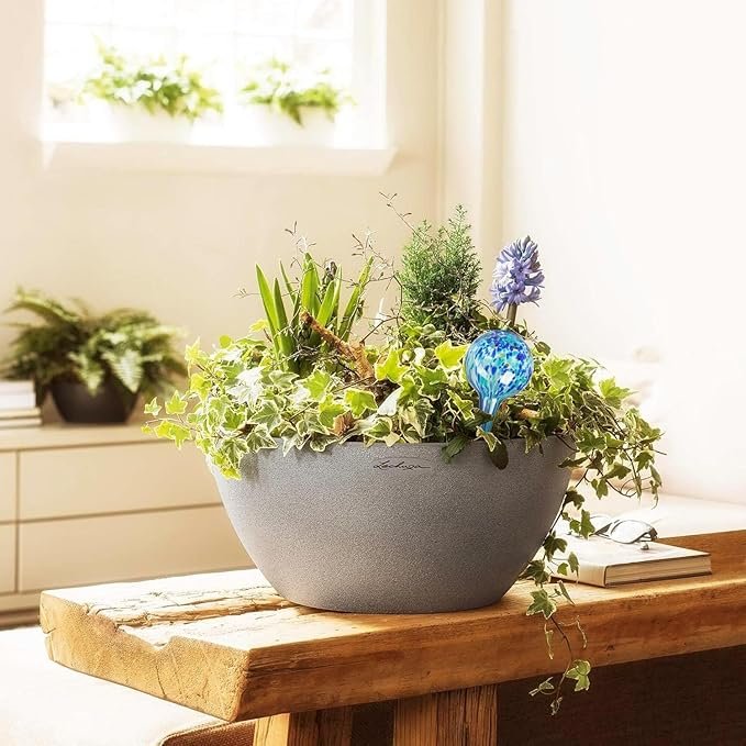 A collage of creative planter ideas for small garden spaces, showcasing upcycled items like a teapot, a hanging colander, yellow rain boots, and a tin can herb garden.